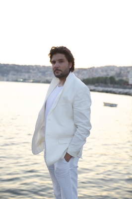 Massimo at the sea with white suite 