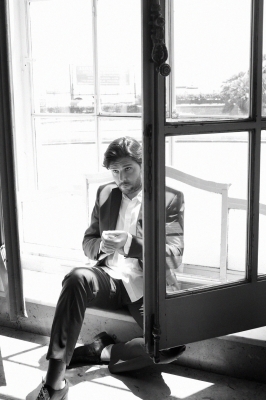 Massimo sits at open window - black / white 